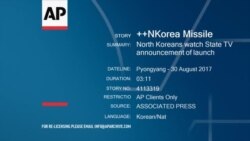 People watching first TV news broadcast on North Korean TV about DPRK's missile launch, Pyongyang, August 30, 2017.