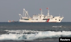 China coast guard vessels are pictured at the disputed Scarborough Shoal on April 5, 2017. (Erik De Castro/Reuters)