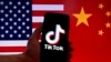 Illustration taken on March 16, 2023 shows the TikTok logo displayed on the screen of an iPhone in front of a US and Chinese flag in Washington, DC. 