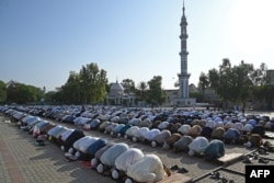 Muslim devotees offer Eid al-Adha prayers at the Eidgah Sharif shrine in Rawalpindi, Pakistan on June 29, 2023. (Aamir Qureshi/AFP)