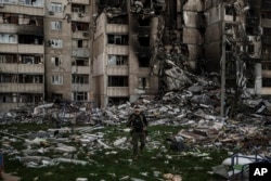 A Ukrainian serviceman walks amid the rubble of a building heavily damaged by multiple Russian bombardments near the frontline in Kharkiv on April 25, 2022.(Felipe Dana/AP)