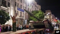 Members of the Wagner Group military company load their tank onto a truck on a street in Rostov-on-Don, Russia, Saturday, June 24, 2023, prior to leaving an area at the headquarters of the Southern Military District. (AP Photo, File)