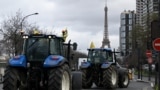 French farmers drive tractors during a protest ahead of the opening of the 60th International Agriculture Fair, on the Quai Andre Citroen, Paris.