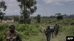 M23 rebels guard the area during the meeting between the East African Regional Force (EACRF) officials and M23 rebels during the handover ceremony at Rumangabo camp in eastern Democratic Republic of Congo on January 6, 2023. (Photo by Guerchom Ndebo / AFP)