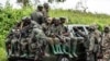 FILE - M23 rebels load a pickup truck in Kibumba, in the eastern of Democratic Republic of Congo, Dec. 23, 2022. .(AP Photo/Moses Sawasawa)