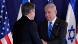 U.S. Secretary of State Antony Blinken, left, and Israel's Prime Minister Benjamin Netanyahu shake hands after their statements to the media inside The Kirya, which houses the Israeli Ministry of Defense, after their meeting in Tel Aviv on October 12, 2023. (Jacquelyn Martin/AP)