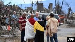 U.S. President Joe Biden and First Lady Jill Biden participate in a blessing ceremony with the Lahaina elders at Moku'ula following wildfires in Lahaina, Hawaii on August 21, 2023. (AFP/Mandel NGAN)