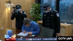 In this image taken from undated video footage run by China's CCTV, Chinese police conduct law enforcement work during a raid at the Capvision office in Shanghai. China's chief foreign intelligence agency has raided the offices of business consulting firm Capvision in Beijing and other Chinese cities as part of an ongoing crackdown on foreign businesses that provide sensitive economic data. (CCTV via AP)