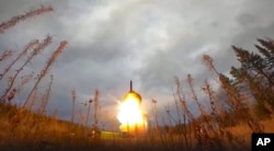 FILE - In this handout photo taken from video released by Russian Defense Ministry Press Service on Oct. 26, 2022, a Yars intercontinental ballistic missile is test-fired as part of Russia's nuclear drills from a site in Plesetsk, Russia. (Handout via AP)
