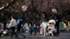 Parents push stroller with their babies in a park in Shanghai, China, April 2, 2023. (REUTERS/Aly Song)