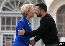 Ukrainian President Volodymyr Zelensky (R) embraces President of the European Commission Ursula von der Leyen (L) after their press-conference in Kyiv on May 9, 2023. (Sergei Supinsky/AFP)