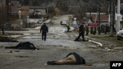 The bodies of civilians lie on Yablunska Street in Bucha, northwest of Kyiv. The first body in the picture has been identified as Mykhailo Kovalenko, who was shot dead by Russian soldiers, according to relatives interviewed by AFP. April 2, 2022. (Photo by RONALDO SCHEMIDT / AFP)