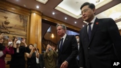 U.S. Secretary of State Antony Blinken, center, walks with Chinese Foreign Minister Qin Gang, right, at the Diaoyutai State Guesthouse in Beijing, China, Sunday, June 18, 2023. (AP/Leah Millis)