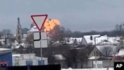 Image capture from a video showing flames rising at the scene of a Russian military transport plane that crashed near Yablonovo, Belgorod region, Russia, on January 24, 2024. (Validated UGC video/AP)