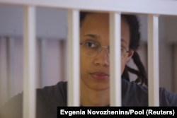 U.S. basketball player Brittney Griner, who was detained at Moscow's Sheremetyevo airport and later charged with illegal possession of hashish oil, stands inside a defendants' cage during the reading of the court's verdict in Khimki, outside of Moscow, on August 4, 2022. (Evgenia Novozhenina/Reuters)