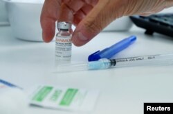 A healthcare worker prepares a syringe at a monkeypox vaccination clinic in Montreal, Quebec, Canada, on June 6, 2022. (Christinne Muschi/Reuters)