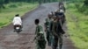 A column of Congolese M23 rebels is seen running on the Goma to Rushuru road as they look for FDLR (Force Democratique de Liberation du Rwanda) returning from an incursion into Rwanda Near Kibumba, north of Goma Tuesday Nov. 27, 2012. (Jerome Delay/AP)