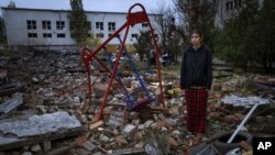 Taisiia Kovaliova, 15, stands next to the rubble of a park in front of her house, which was hit by a Russian missile in Mykolaiv on Ocober. 23, 2022. (Emilio Morenatti/AP)