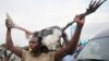 A protester carries a Marabou stork during a demonstration following the announcement of the results of Kenya's presidential election, in Kisumu, August 15, 2022. (James Keyi/Reuters)