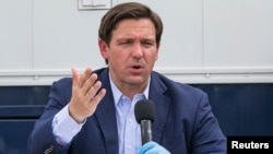 Florida Governor Ron DeSantis speaks during a news conference at the Miami Beach Convention Center on the Army Corps' building of a coronavirus field hospital inside the facility, in Miami Beach, Florida, U.S. April 8, 2020. Al Diaz/Pool via REUTERS
