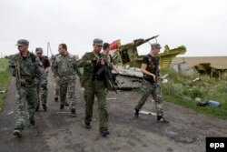 Ukraine -- The Pro-Russian self-proclaimed governor of the Donetsk region Pavel Gubarev (3-L) looks at the Boeing 777, Malaysia Arilines flight MH17 debris, which was shot down over eastern Ukraine on July 18, 2014