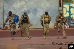 This undated photograph handed out by French military on Jan. 6, 2022, shows three Russian mercenaries, right, in northern Mali. (French Army via AP)
