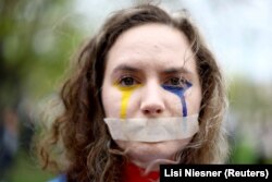 A woman in Berlin takes part in a demonstration, "The real price of Russian gas and oil," to protest against Russia's invasion of Ukraine on April 21, 2022. (Lisi Niesner/Reuters)