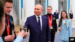 Russian President Vladimir Putin meets with Russian athletes in the Kremlin in Moscow, Russia, April 26, 2022. 