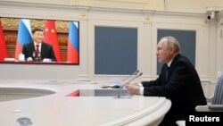 Russia's President Vladimir Putin holds talks with China's President Xi Jinping via a video link from Moscow, Russia, December 30, 2022. Sputnik/Mikhail Kuravlev/Kremlin via REUTERS