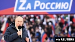 Russian President Vladimir Putin delivers a speech during a rally at Luzhniki Stadium in Moscow, March 18, 2022. The banner reads: "For Russia," using the untraditional "Z" representative of Russia's campaign in Ukraine. (Sputnik/Kremlin via Reuters)