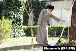 IRAN -- Iranian Supreme Leader Ayatollah Ali Khamenei uses protective gloves as he attends a tree planting ceremony in Tehran, March 3, 2020