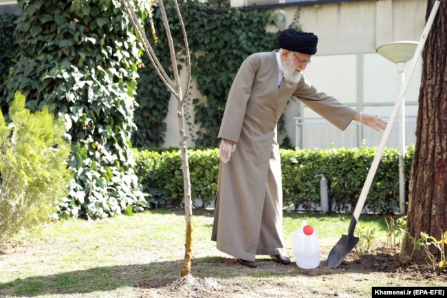 IRAN -- Iranian Supreme Leader Ayatollah Ali Khamenei uses protective gloves as he attends a tree planting ceremony in Tehran, March 3, 2020