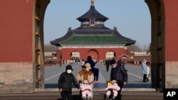 Visitors wear masks as they visit the Temple of Heaven park in Beijing, December 8, 2022. China announced a potentially major easing of its rigid "zero-COVID" rules without formally abandoning the policy altogether. (Ng Han Guan/AP)