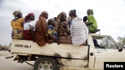 Women travel in the town of Mararaba after the Nigerian military recaptured it from Boko Haram, in Adamawa state, May 10, 2015. (Akintunde Akinleye/Reuters)