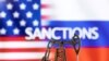 A model of a pump jack is seen in front of the displayed word "Sanctions;" U.S. and Russian flag colors in this illustration taken March 8, 2022. (Dado Ruvic/REUTERS)