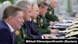 RUSSIA -- Russian President Vladimir Putin (Third Left) visits the National Defence Control Centre (NDCC) to oversee the test of a new Russian hypersonic missile system called Avangard, which can carry nuclear and conventional warheads, in Moscow, Russia 