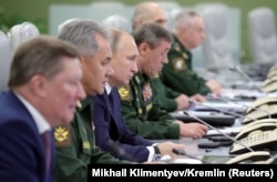 RUSSIA -- Russian President Vladimir Putin (Third Left) visits the National Defence Control Centre (NDCC) to oversee the test of a new Russian hypersonic missile system called Avangard, which can carry nuclear and conventional warheads, in Moscow, Russia.