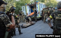 UKRAINE – Ukrainian soldiers rescue an injured comrade during fighting against militants, close to Ilovaysk, near Donetsk, August 10, 2014.