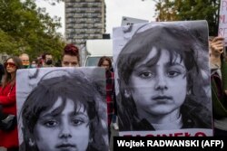 In Warsaw, a woman holds a banner with a portrait reading "Missing Child" during a rally in solidarity with migrants who have allegedly been pushed back at Poland's border with Belarus, October 17, 2021. (Wojtek Radwanski/AFP)