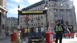 A police officer stands in front of Oxford Circus subway station in London following an easing of lockdown guidelines, on May 14, 2020.