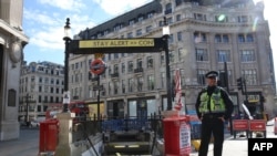 A police officer stands in front of Oxford Circus subway station in London following an easing of lockdown guidelines, on May 14, 2020.