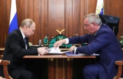 Russian President Vladimir Putin (L) meets with the Head of Russian state space agency Roskosmos Dmitry Rogozin at the Kremlin in Moscow, August 1, 2019.