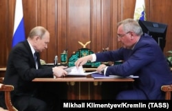 Russian President Vladimir Putin (L) meets with the Head of Russian state space agency Roskosmos Dmitry Rogozin at the Kremlin in Moscow, August 1, 2019.