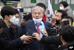 In this April 20, 2020, photo, Sarang Jeil Church pastor Jeon Kwang-hun speaks outside a detention center in Uiwang, South Korea. Jeon, who has been a bitter critic of the country's president, has tested positive for the coronavirus, health authorities said.