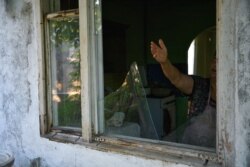 ARMENIA-AZERBAIJAN-CONFLICT -- Evelina Hovhanisyan, 70, points at the window of her house in the village of Aygepar in Tavush region damaged by recent shelling during armed clashes on the Armenian-Azerbaijani border on July 15, 2020.