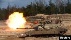U.S. Army M1A1 Abrams tank fires during NATO enhanced Forward Presence battle group military exercise Crystal Arrow 2021 in Adazi, Latvia March 26, 2021 REUTERS/Ints Kalnins/File Photo