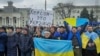  People hold Ukrainian flags and a banner that reads "Kherson is Ukraine" during a rally against Russian occupation in Svobody (Freedom) Square in Kherson, March 5, 2022. (Associated Press)