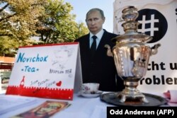 GERMANY -- A mock offer of "Novichok Tea" is seen in front of an effigy of Russian President Vladimir Putin outside the Russian embassy in Berlin, September 23, 2020.