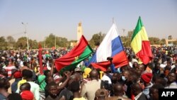 Demonstrators gather in Ouagadougou to show support to the military while holding and waiving a Russian flag in the aftermath of the coup d'etat in Burkina Faso which overthrew President Roch Marc Christian Kabore, January 25, 2022. (AFP)