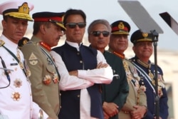 Pakistan's Prime Minister Imran Khan (3L) and President Arif Alvi (3R) watch fighter jets perform during the Pakistan Day parade in Islamabad on March 23, 2022. (Ghulam Rasool / AFP)